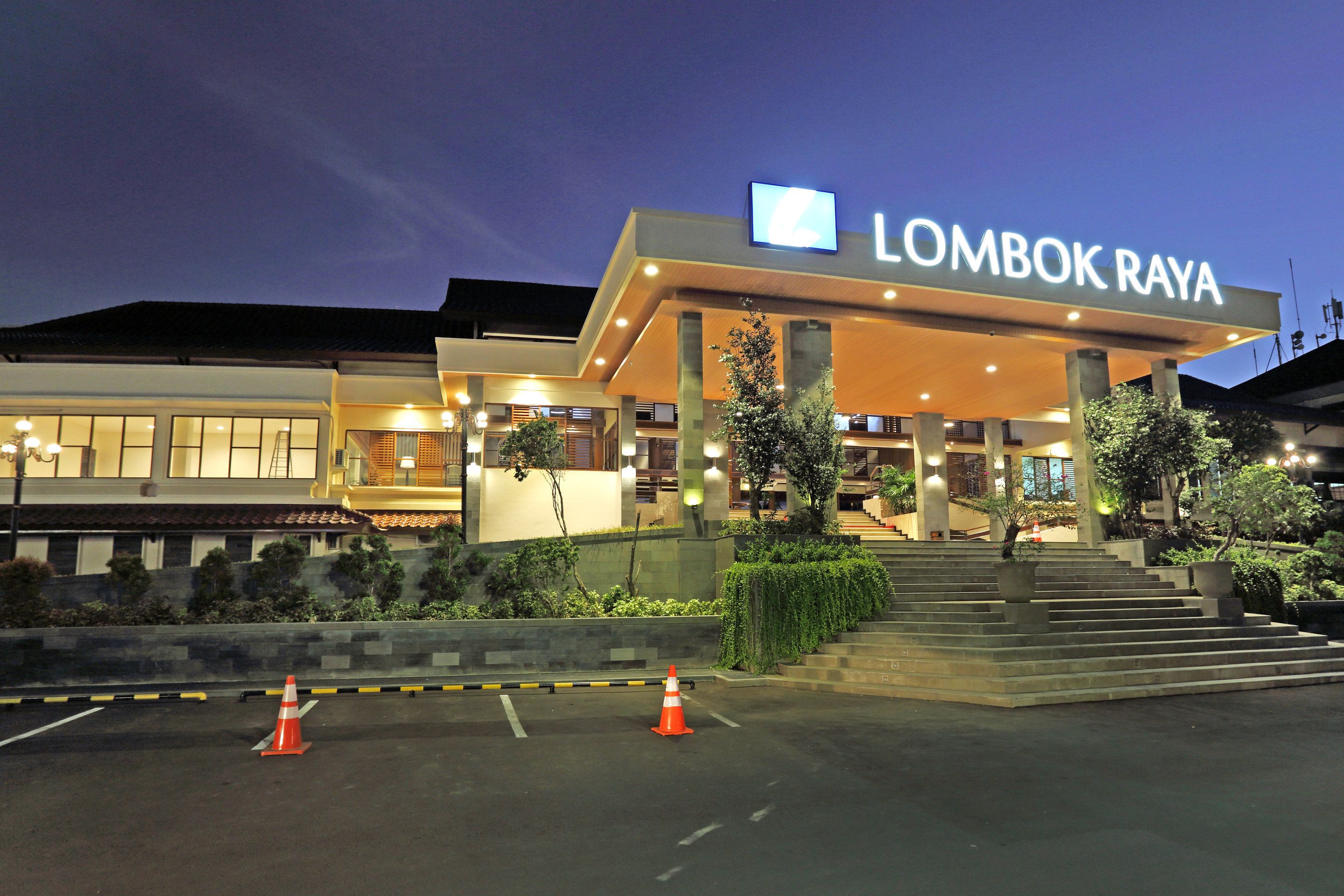A hotel entrance with a sign reading "LOMBOK RAYA".