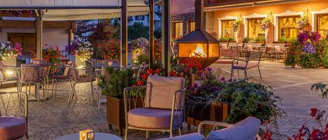 An outdoor patio area with seating and a fire feature.