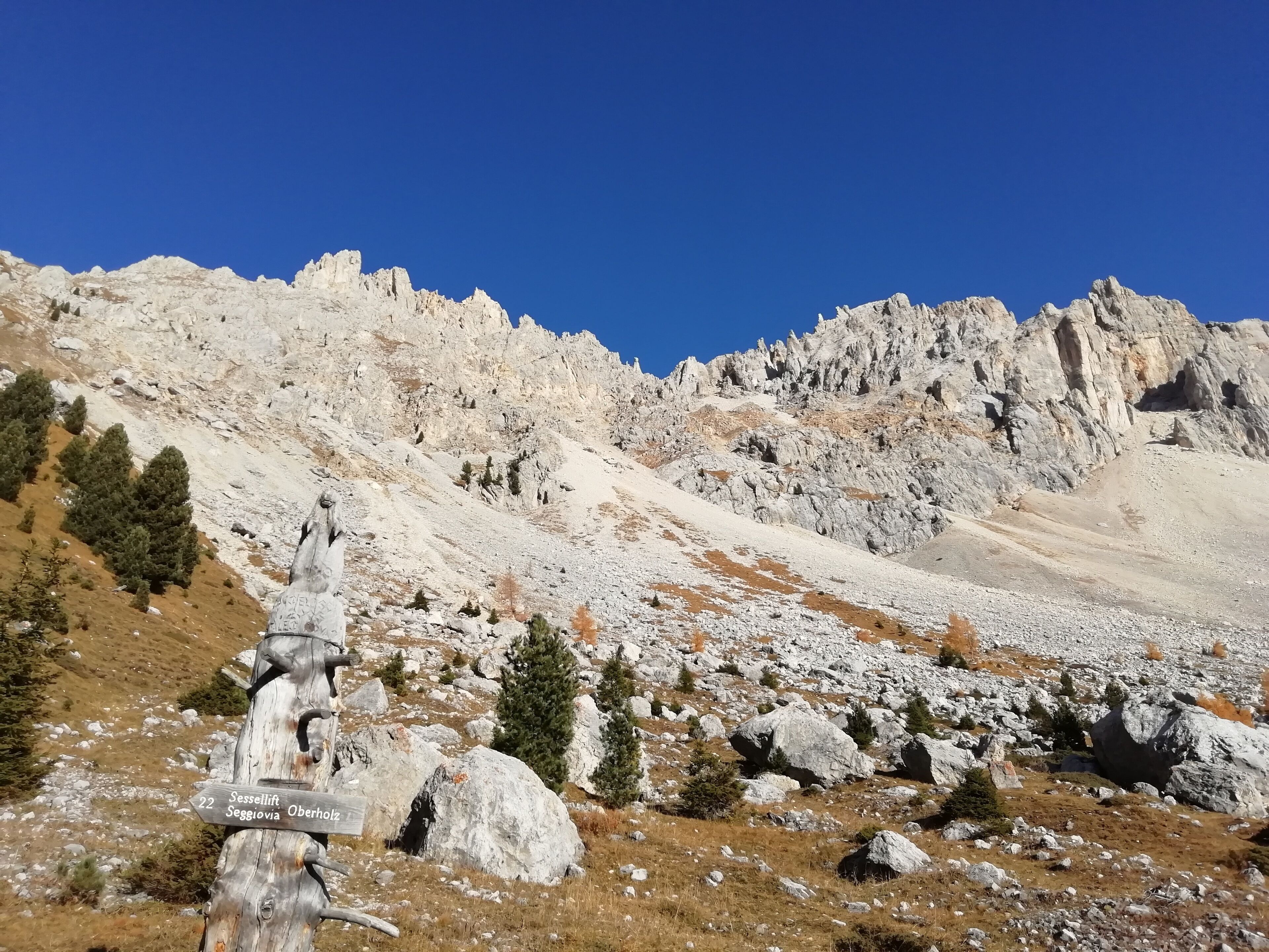 A mountain landscape with rocky terrain and sparse vegetation.