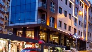 A modern hotel building with a prominent sign reading "Urban Hotel."
