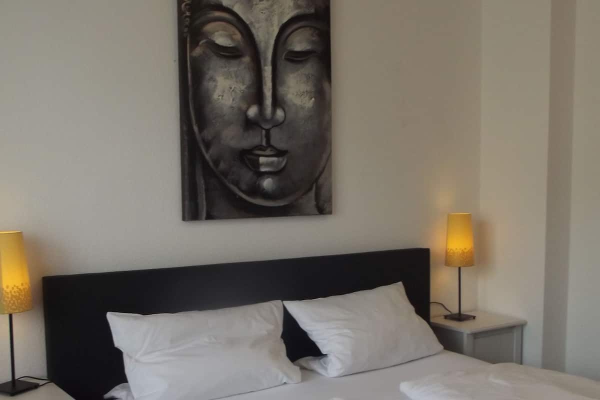 Premium bedding, desk, laptop workspace, blackout drapes