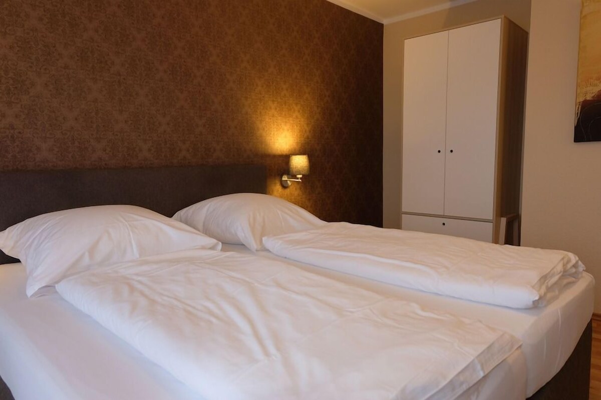 Premium bedding, desk, laptop workspace, blackout curtains