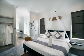 A modern bedroom with a large bed, a canopy, and a bedside table with a plant.
