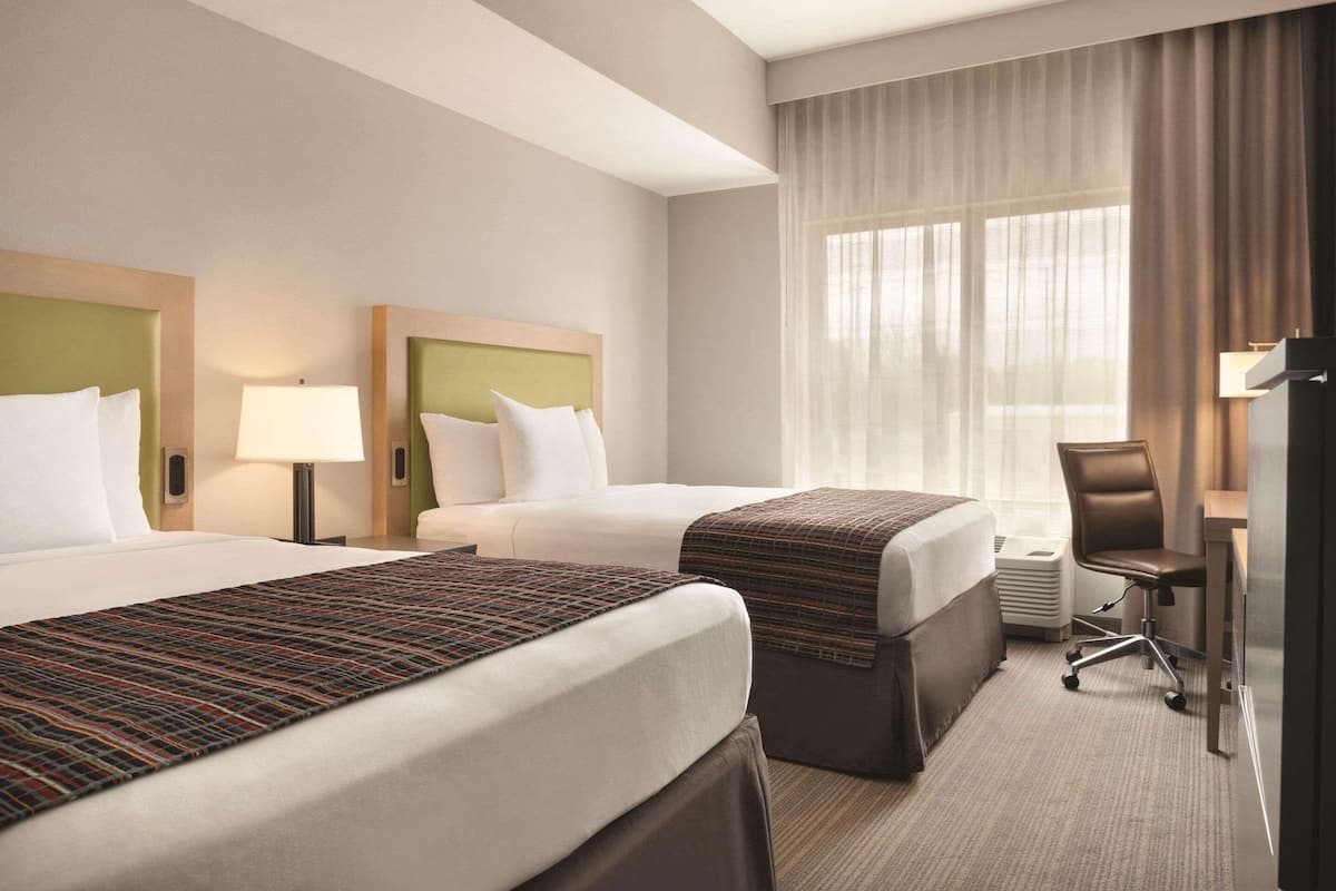 pillow-top beds, desk, laptop workspace, blackout curtains