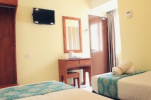 A hotel room with two beds, a desk with a chair, a television mounted on the wall, and a door with curtains. - Sun Inns Hotel Equine Seri Kembangan (Seri Kembangan)