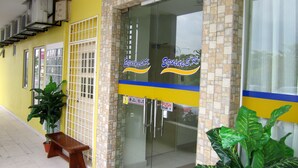 A storefront with a yellow exterior, glass doors, and a sign reading "Equine S.K." - Sun Inns Hotel Equine Seri Kembangan (Seri Kembangan)
