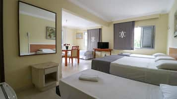 Triple Room, Partial Sea View | Minibar, in-room safe, individually decorated, desk