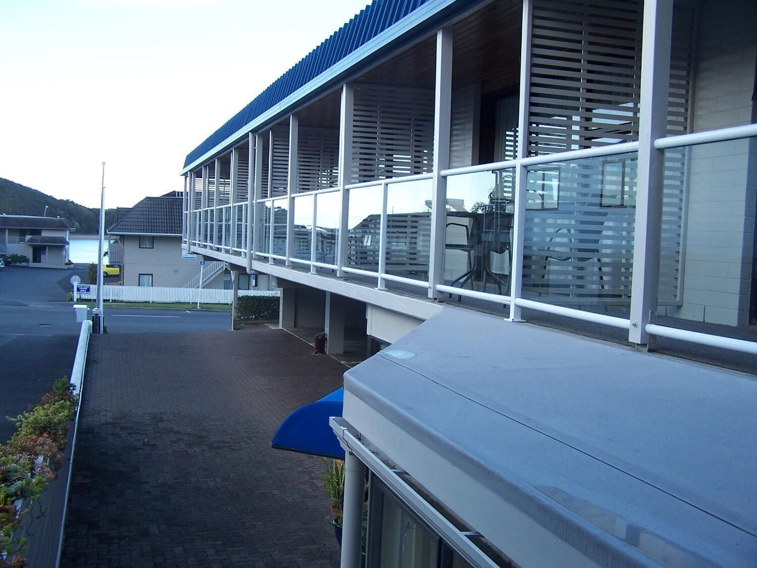 A modern building with a covered walkway and large windows.