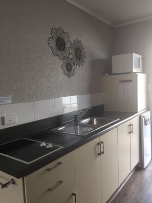 Fridge, microwave, stovetop, coffee/tea maker