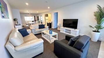 Deluxe Apartment | Living area | 32-inch Smart TV with digital channels