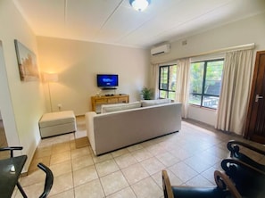 Family Apartment, 2 Bedrooms, Garden Area | Living area | 64-inch Smart TV with satellite channels