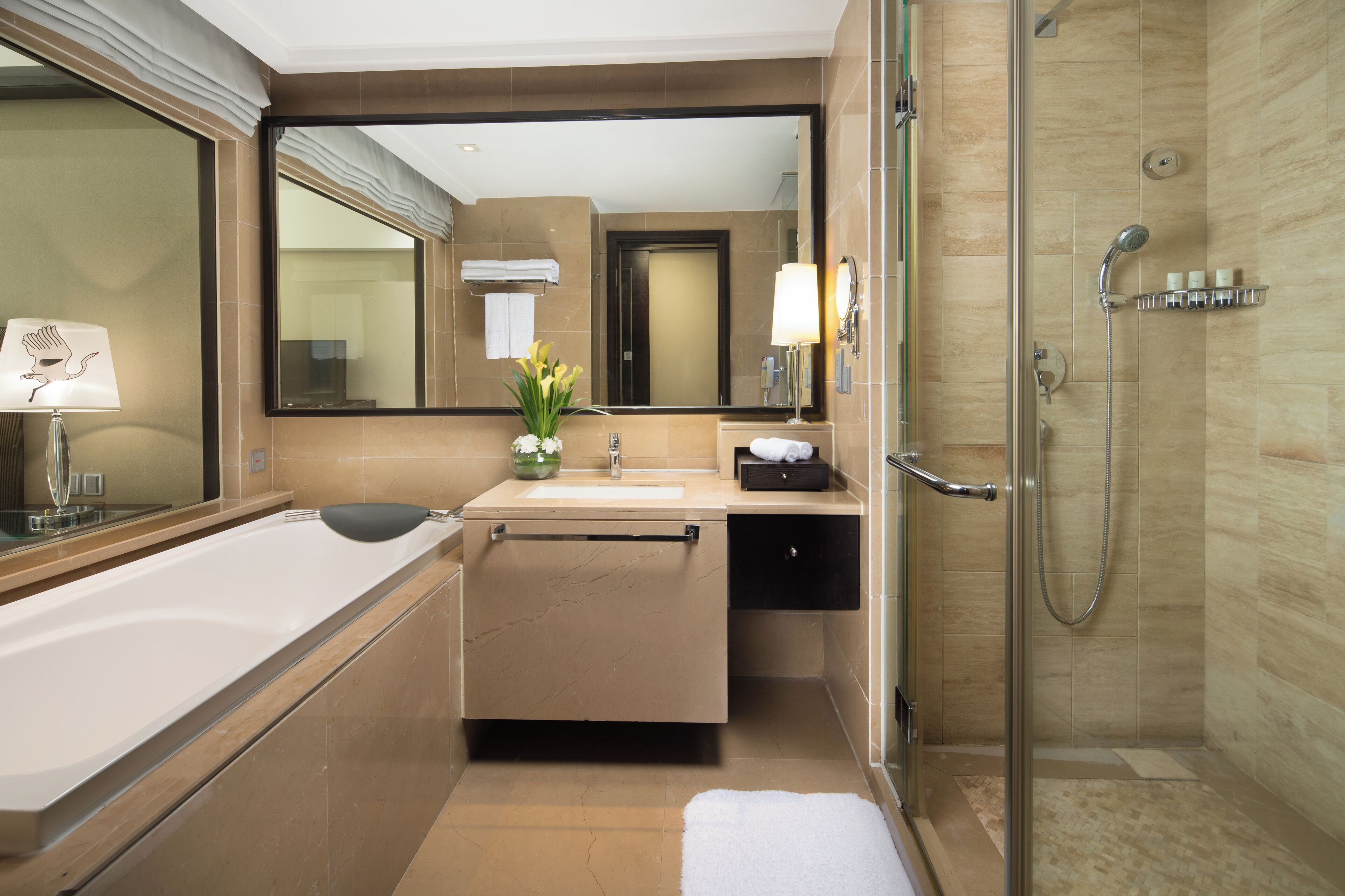 A modern bathroom with a bathtub, sink, and shower.