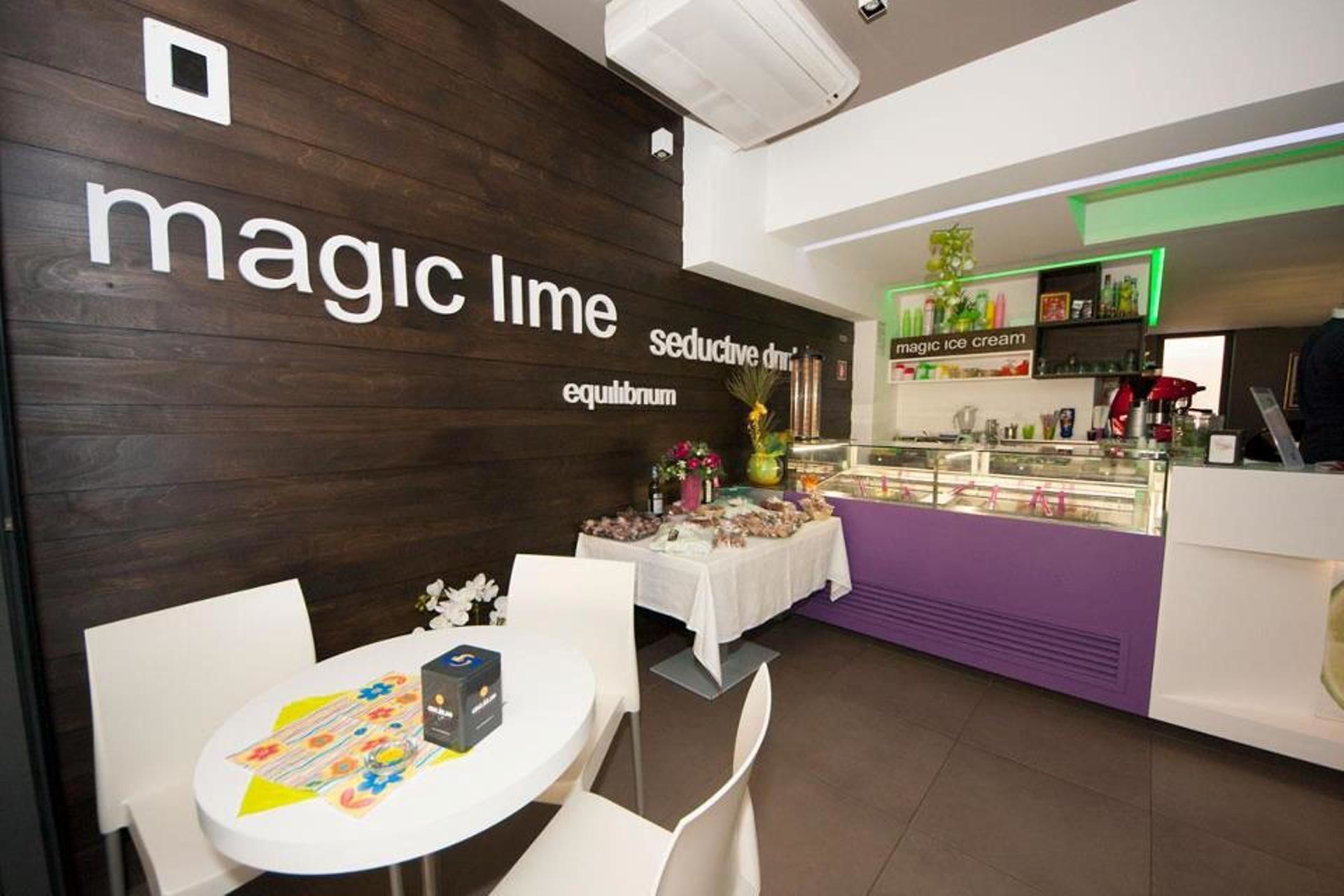 A restaurant interior with a dark wooden wall, a counter with a purple and white color scheme, and a table with a box and a menu.