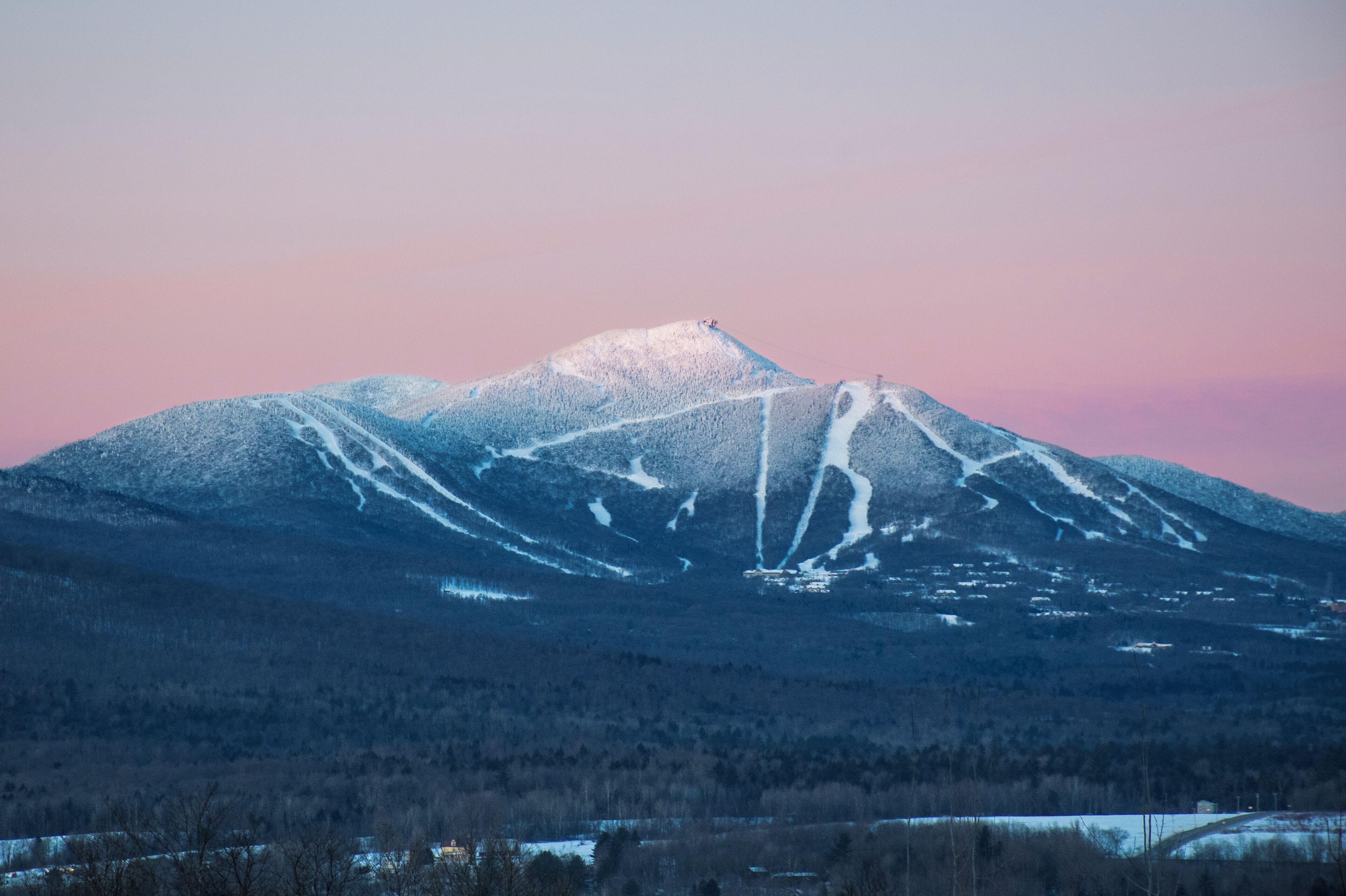A snow-covered mountain with ski trails.
