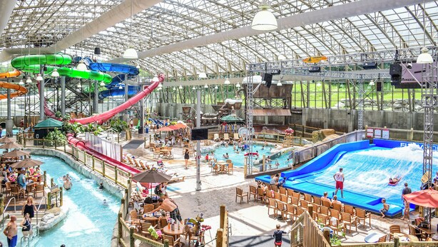 An indoor water park with slides, pools, and seating areas. - Jay Peak Resort (North Troy)