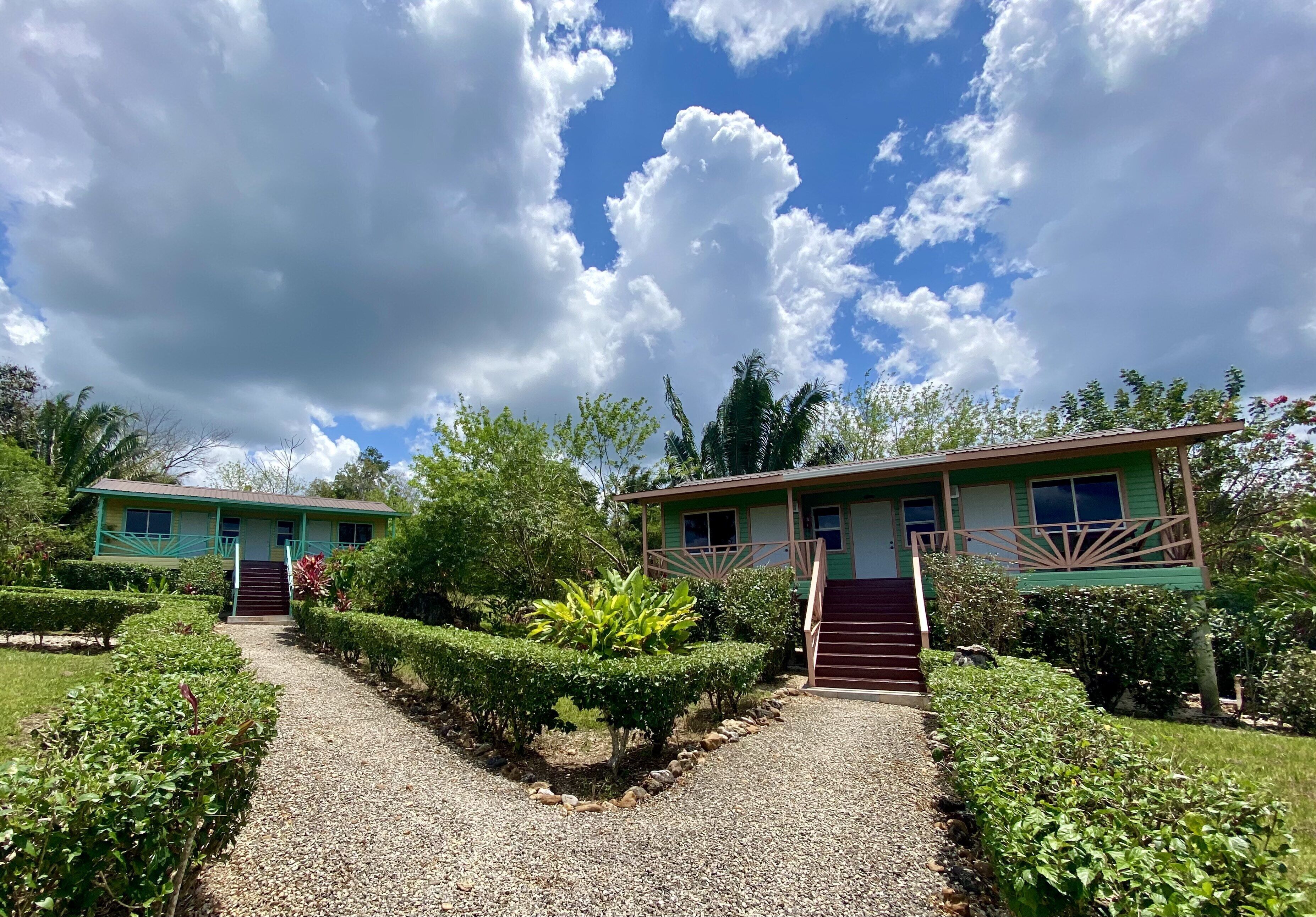A two-story building with a gravel pathway leading to the entrance.