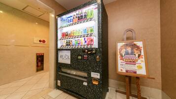 A vending machine with various beverages and a sign for RESOL.