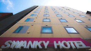 A high-rise building with the Swanky Hotel sign at the bottom. - Swanky Hotel Otomo (Sapporo)