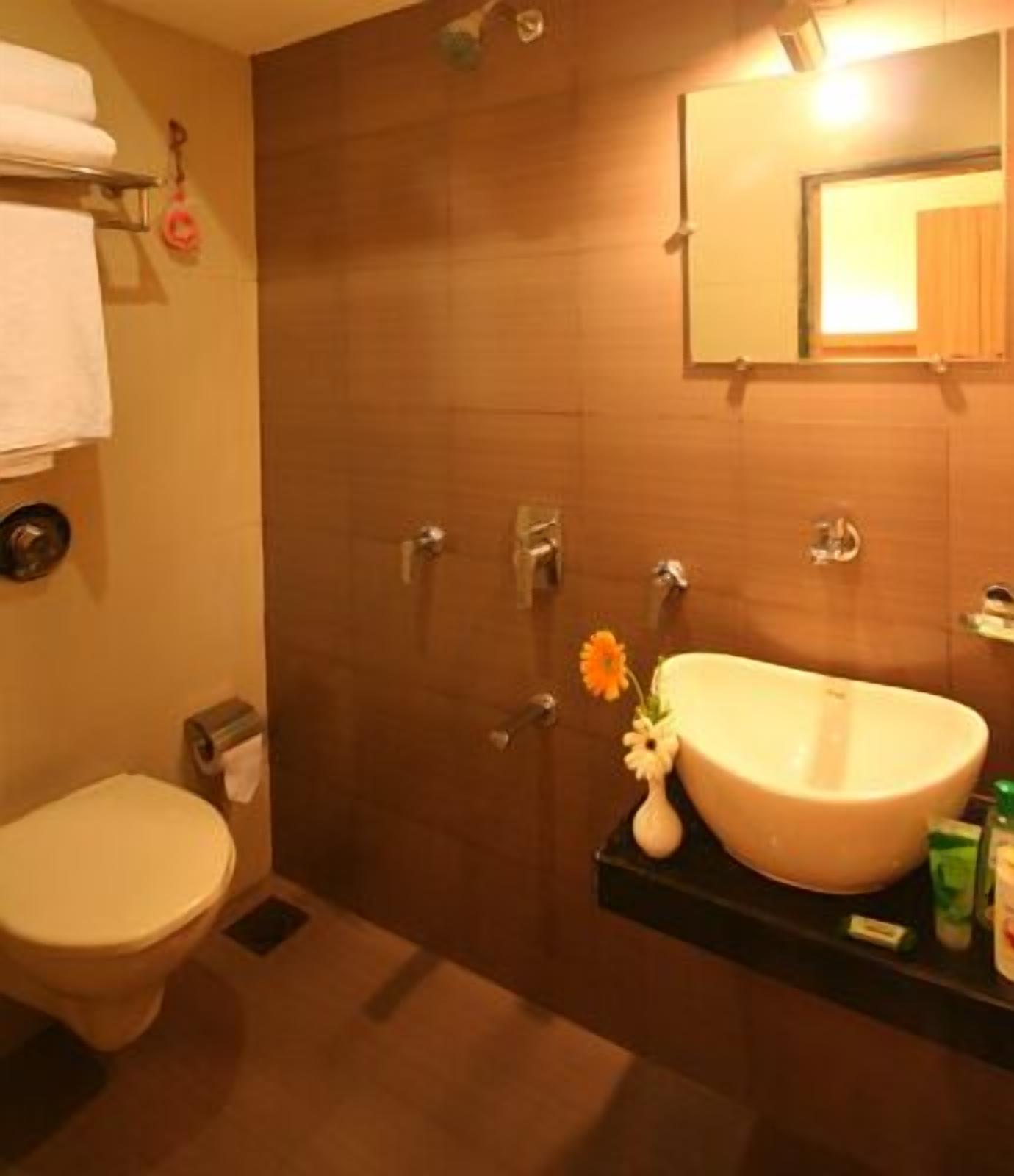 A bathroom with a toilet, a sink, and a shower.