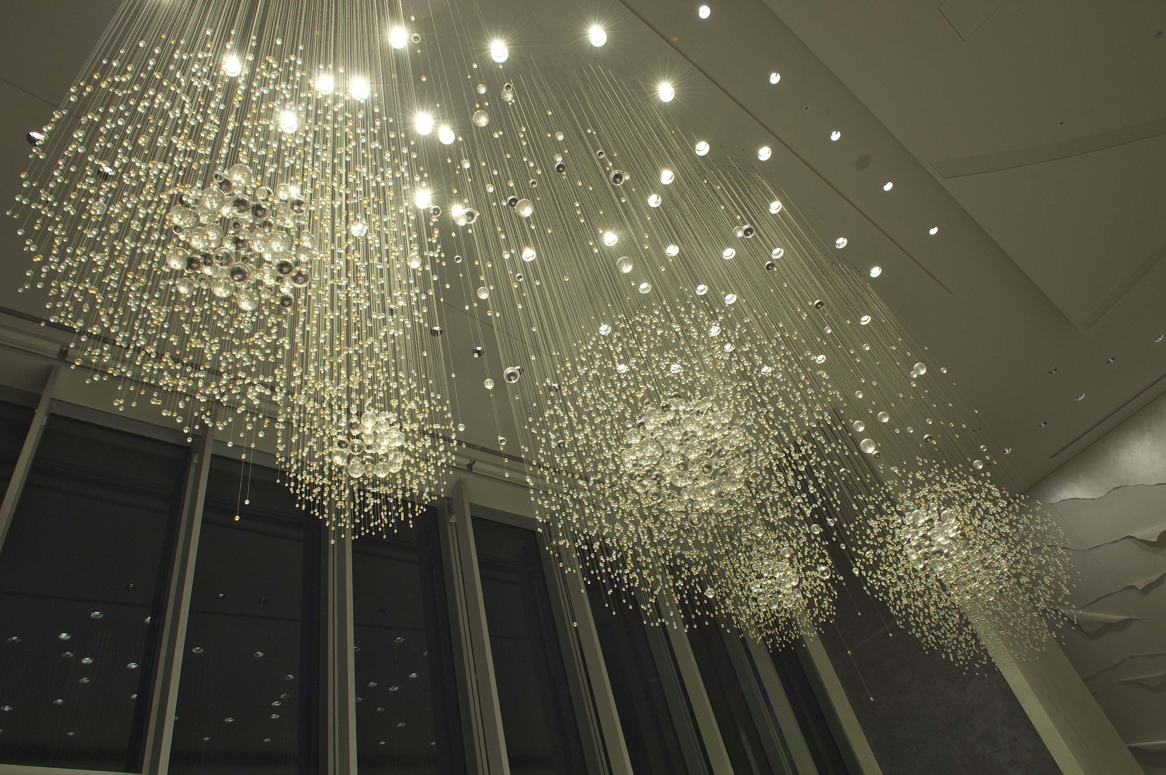 A chandelier with multiple hanging lights and reflective elements.