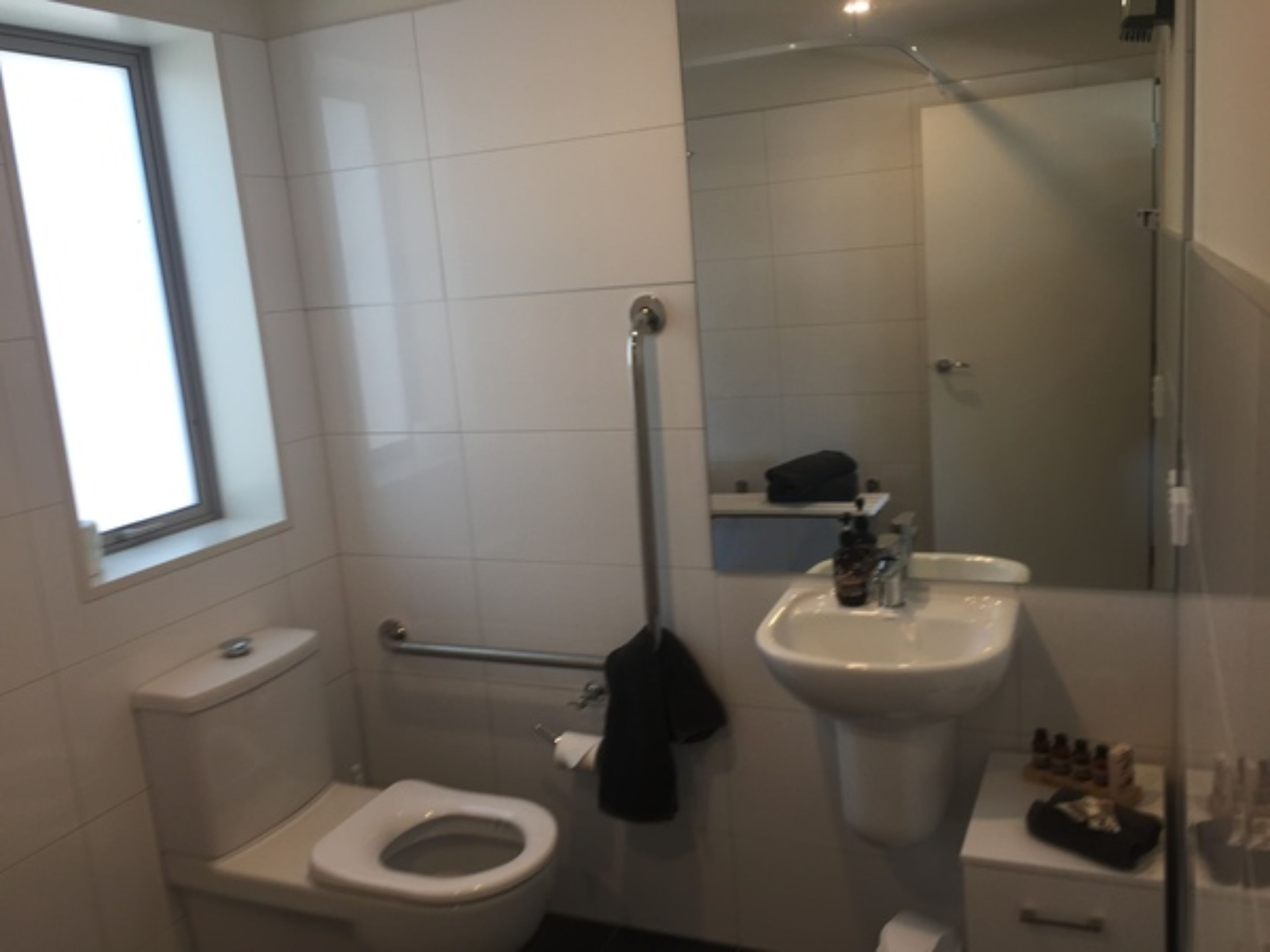A modern bathroom with a toilet, bidet, and sink.