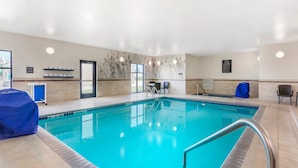 An indoor swimming pool with a clear view of the pool area, a covered seating area, and a spa rules sign on the wall. - Sleep Inn & Suites Devils Lake (Devils Lake)
