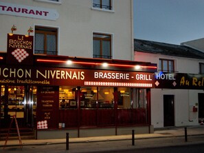 A restaurant named 'Le Bouchon Nivernais' with a sign indicating it offers traditional cuisine and a grill. - Logis Hotel Au Relais Nivernais (Nevers)