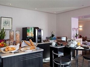 Une cuisine moderne dotée d’un espace dédié au café, d’un bar et de coins salon.