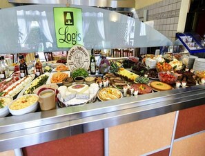 A buffet with a variety of food items and a sign that reads "Logis." - Hôtel Le Relais du Parisis (Villeparisis)