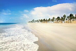 On the beach, sun loungers, beach umbrellas, beach towels - Salalah Rotana Resort (Salalah)