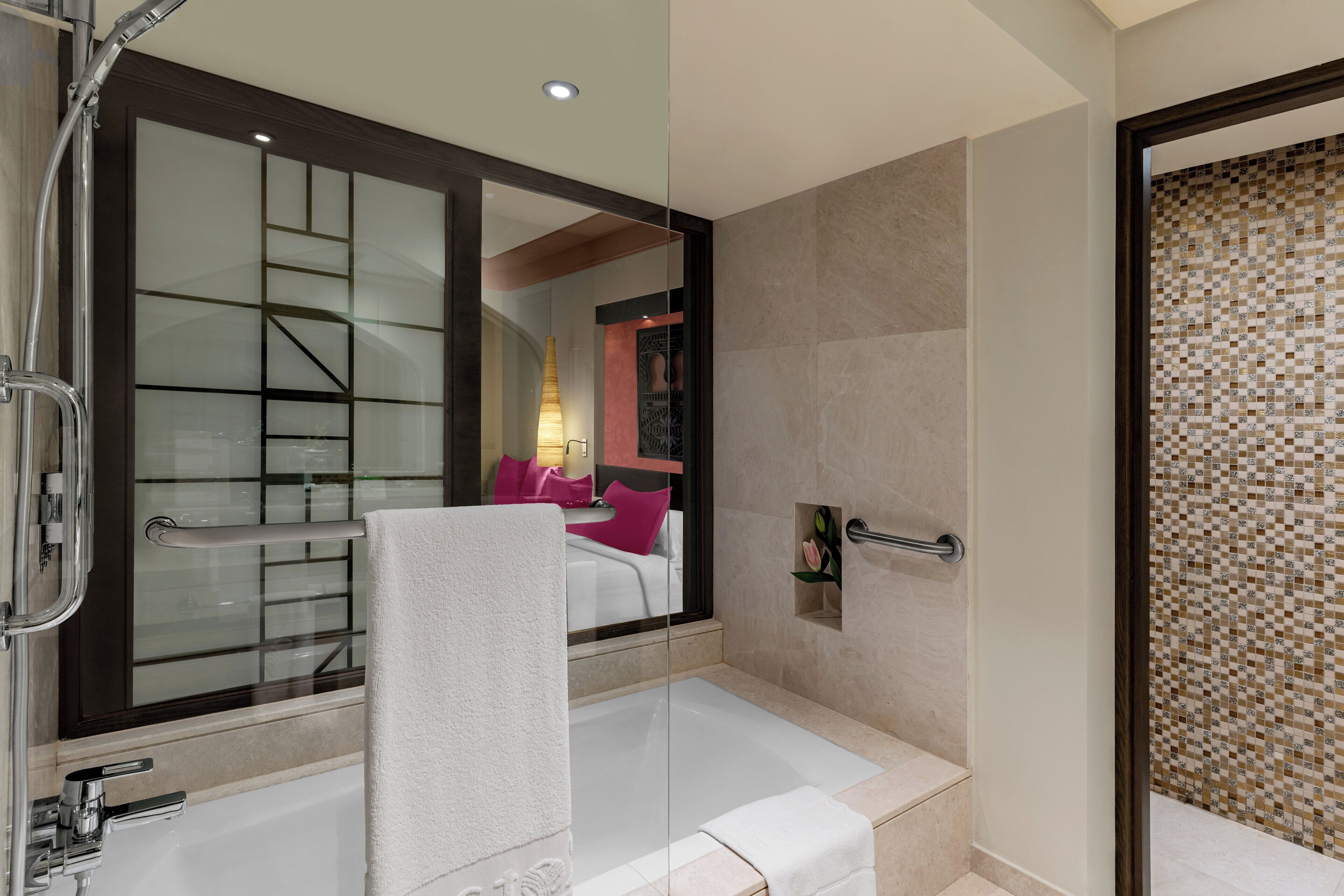 A modern bathroom with a glass-enclosed shower, a bathtub, and a large mirror.
