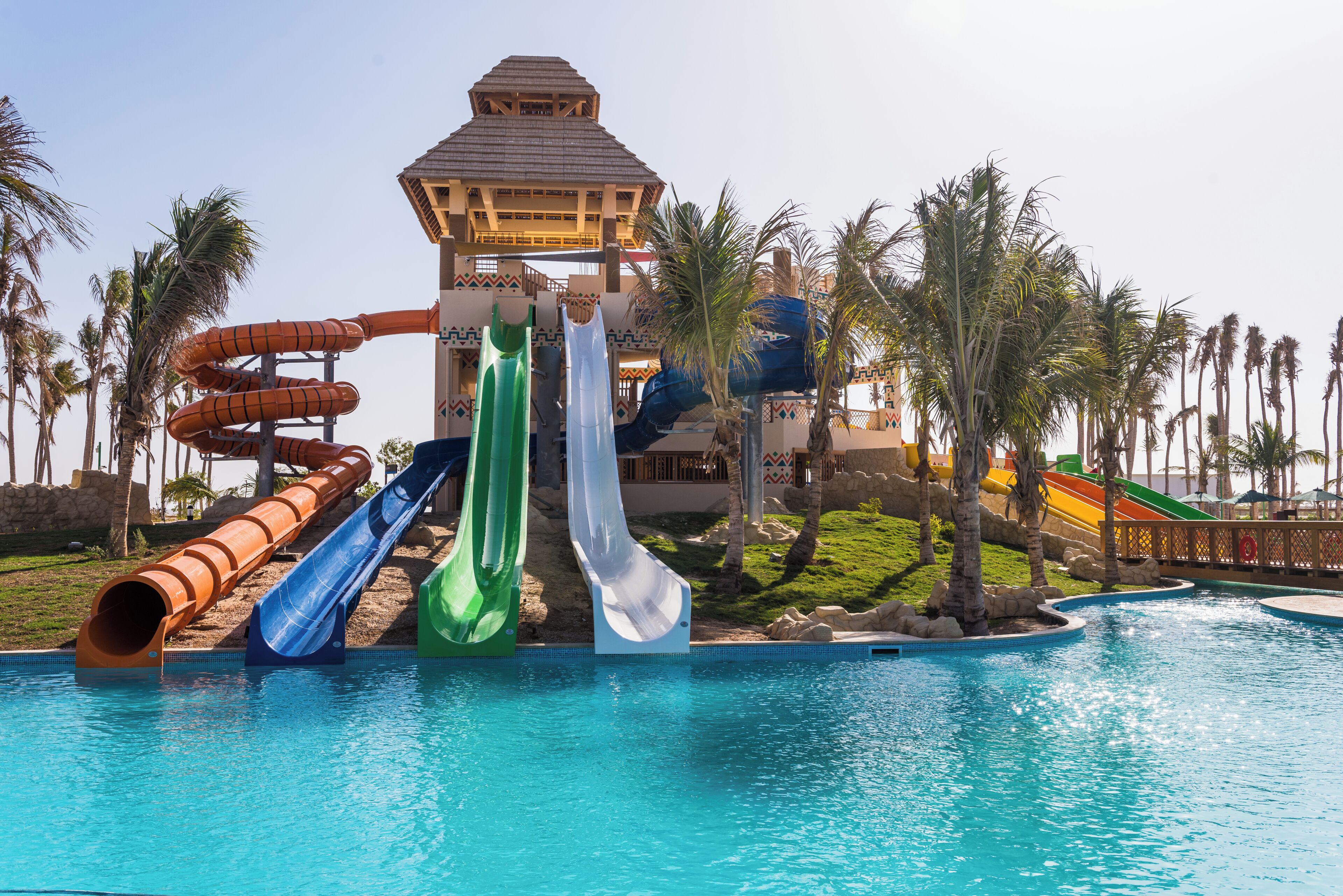 A water park with multiple slides and a pool.