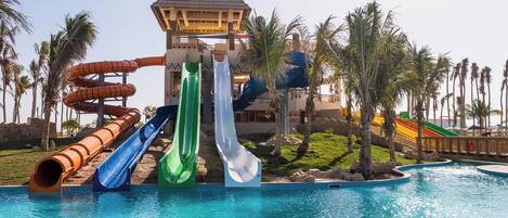 A water park with multiple slides and a pool.