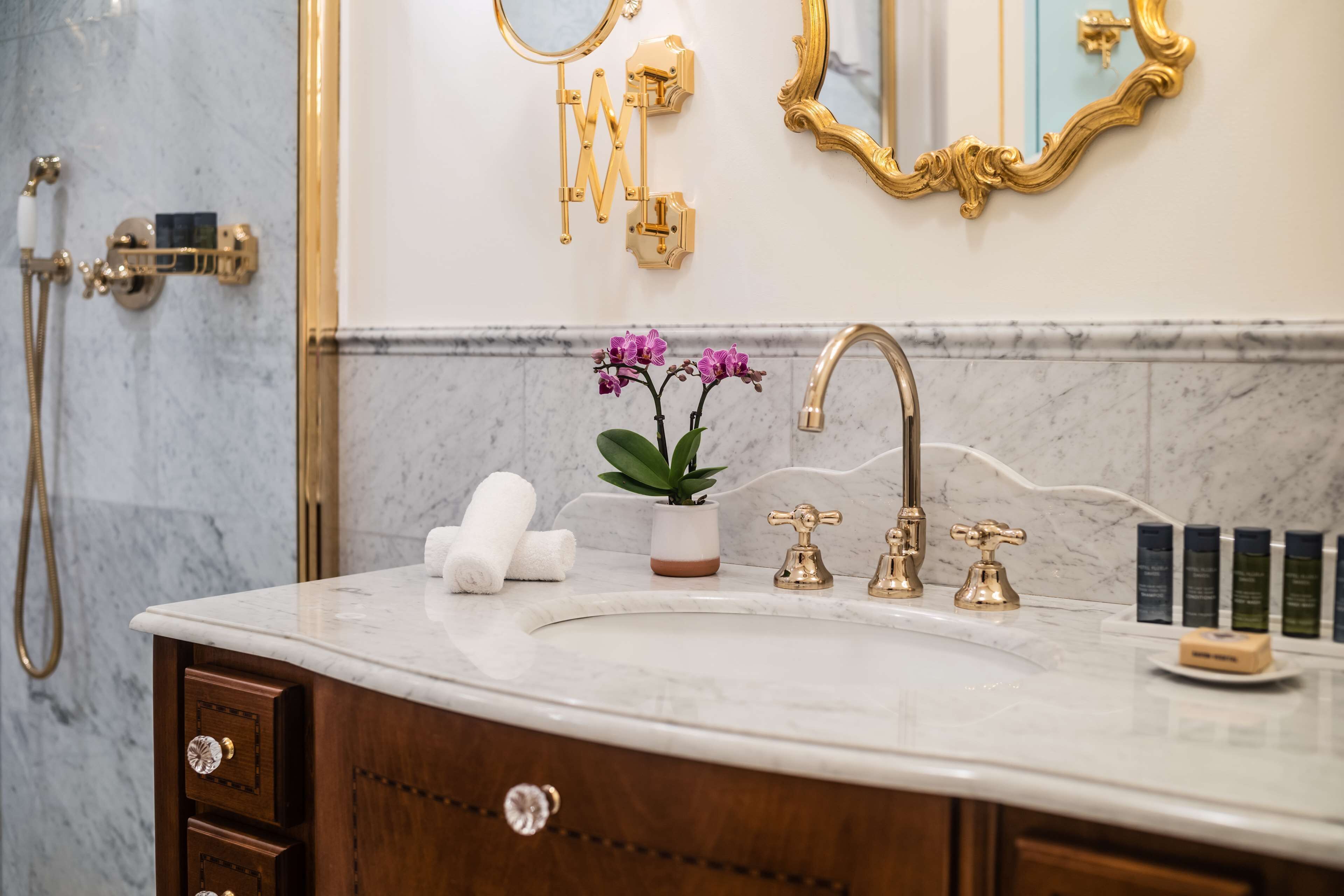 designer toiletries, hair dryer, bathrobes, slippers