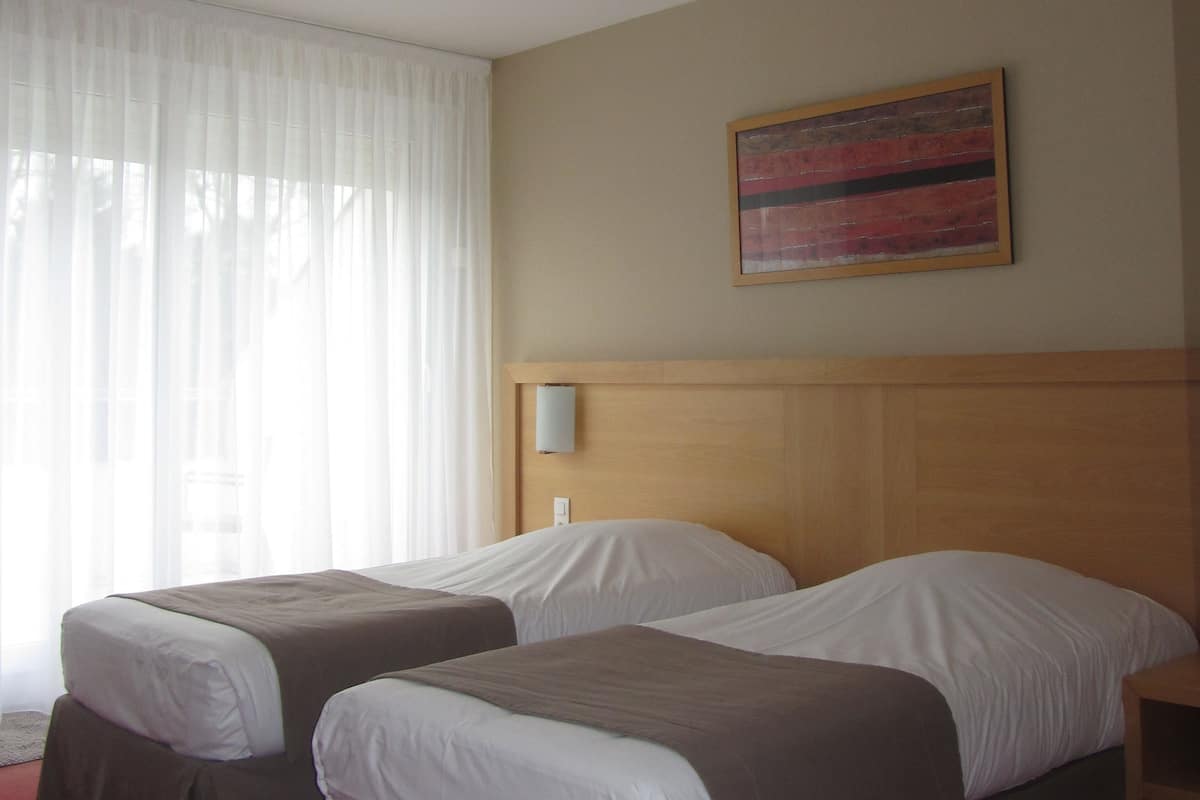Chambre avec lits jumeaux | Coffre-fort, bureau, systĂšme dâinsonorisation, fer et planche Ă repasser