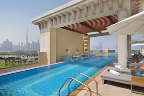 Outdoor pool, open 7:00 AM to 9:00 PM, pool umbrellas, pool loungers