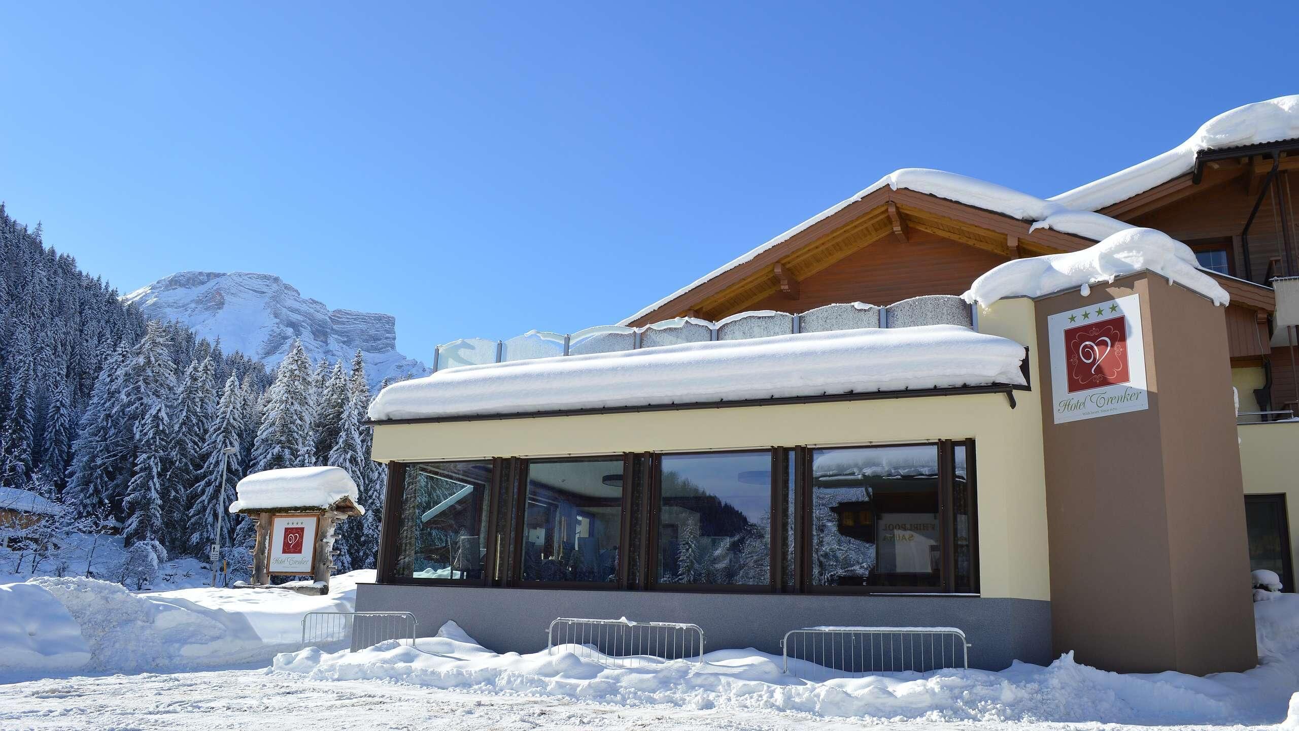 Ein Hotel mit verschneitem Dach und Bergblick.