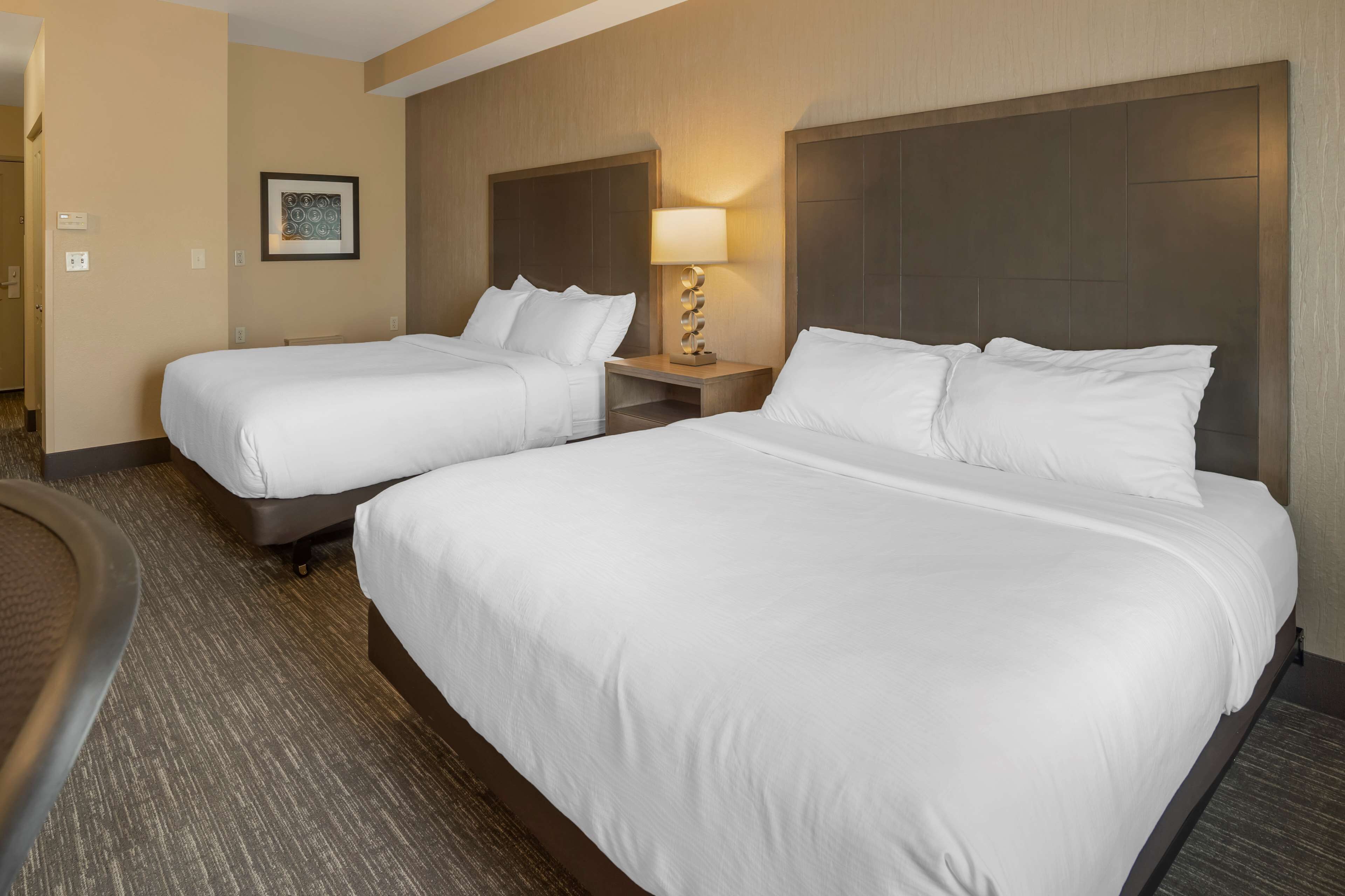 pillow-top beds, desk, laptop workspace, blackout curtains