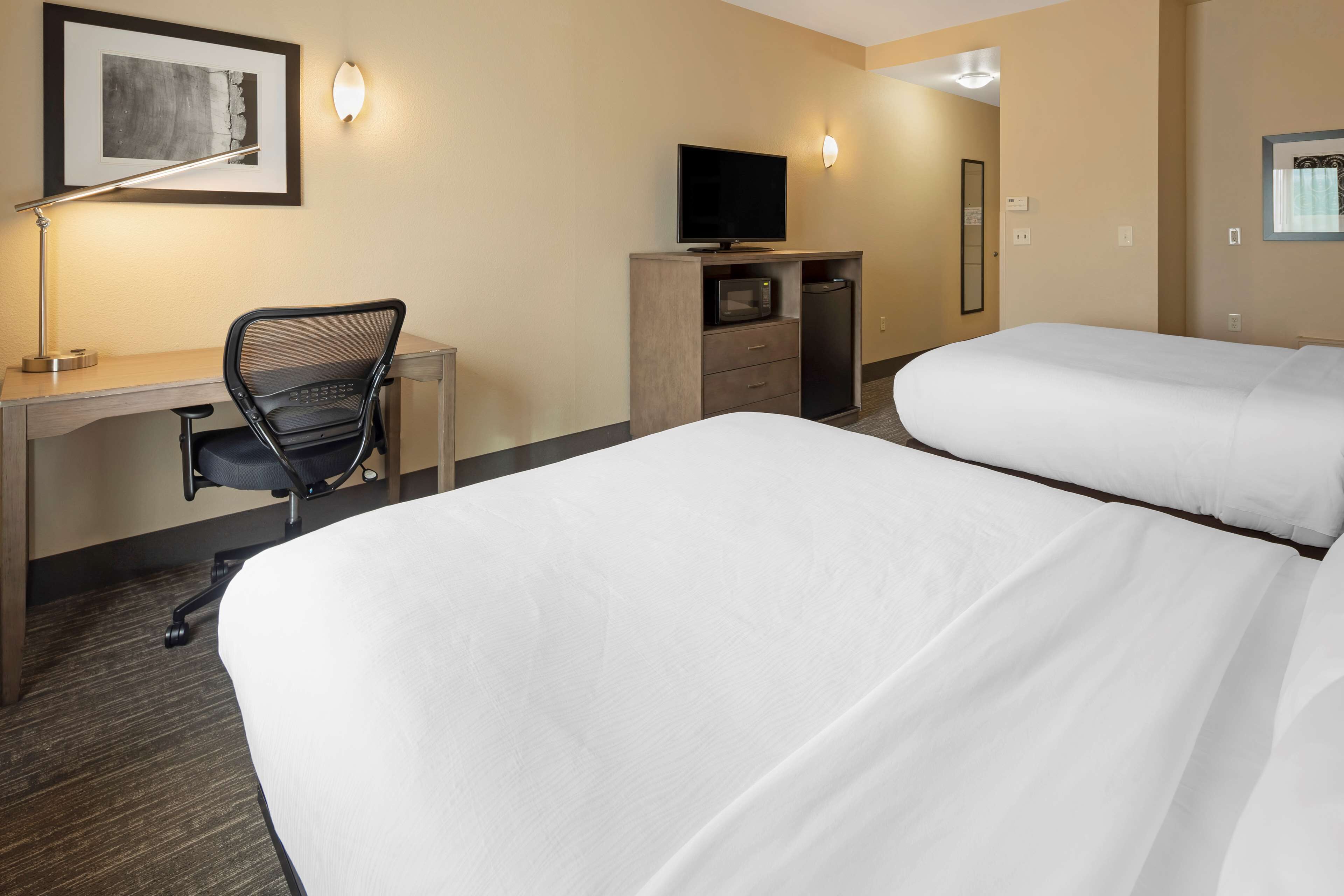 pillow-top beds, desk, laptop workspace, blackout curtains