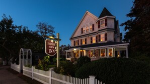 A large, two-story building with a prominent sign reading "Palmer House Inn."