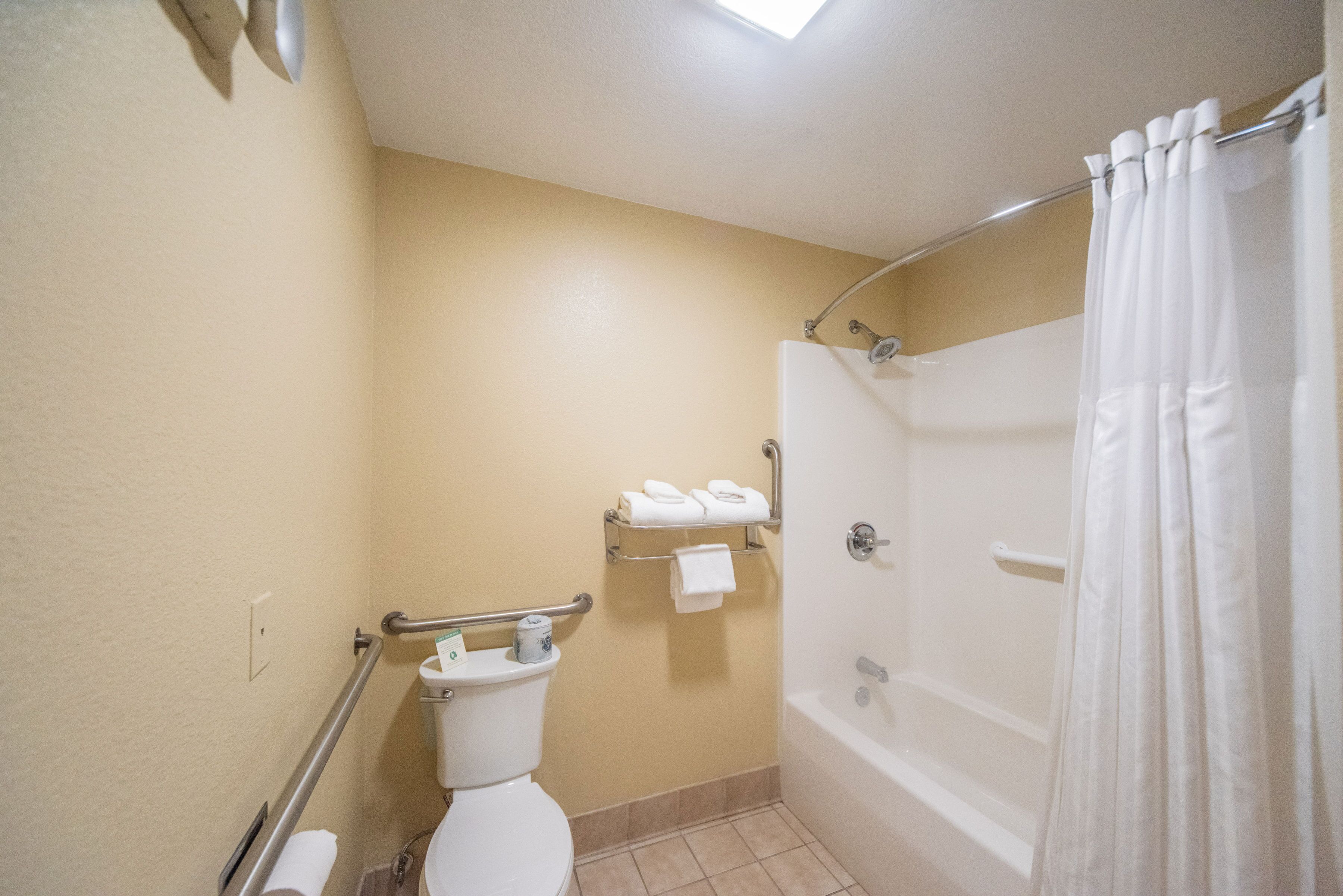 A bathroom with a toilet, a shower, and a bathtub.