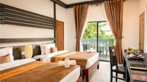 A hotel room with two beds, a balcony, a dining table, and a view of greenery. - Reveal Courtyard in Reveal Angkor (Siem Reap)