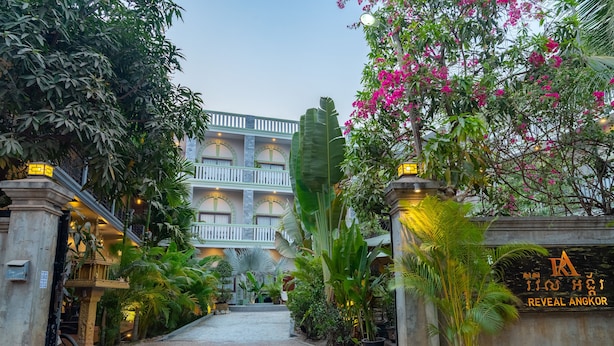 A hotel entrance with a pathway leading to a multi-story building. - Reveal Courtyard in Reveal Angkor (Siem Reap)