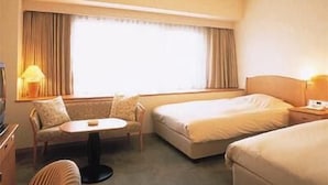 A hotel room with a bed, a chair, a small table, and a TV. -  KOBE LUMINOUS HOTEL HYOGOEKIMAE (Kobe)