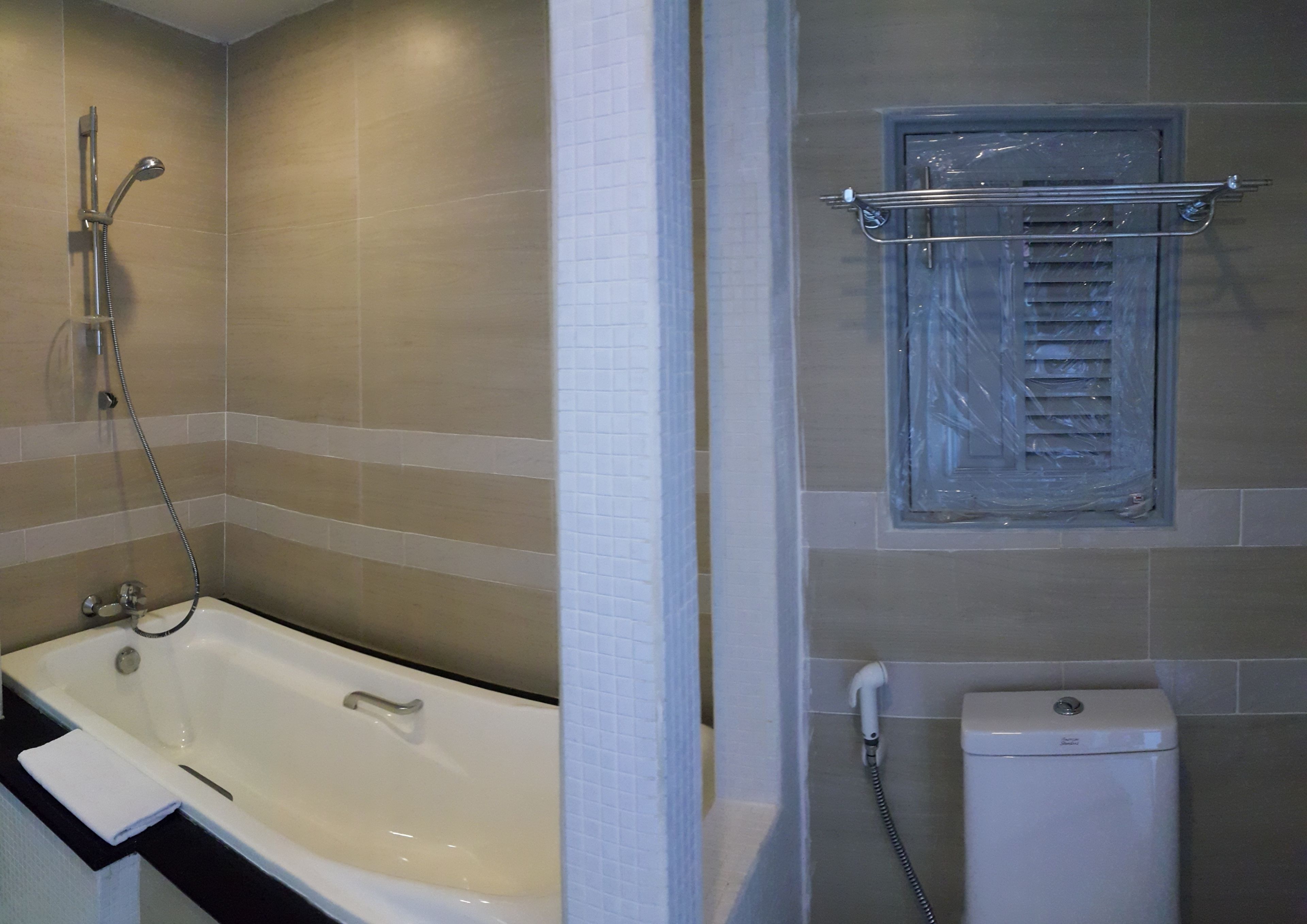 A bathroom with a bathtub, a shower, and a toilet.