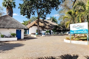 A reception area at a resort with a sign indicating the location.