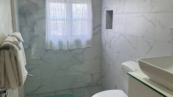 Suite, 1 Bedroom | Bathroom | Combined shower/tub, rainfall showerhead, free toiletries, towels