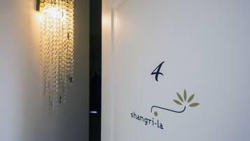 A wall with a chandelier and a logo that reads "4 Shangri-la".