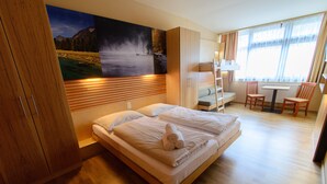 Une chambre à coucher avec un lit, un bureau et une chaise.