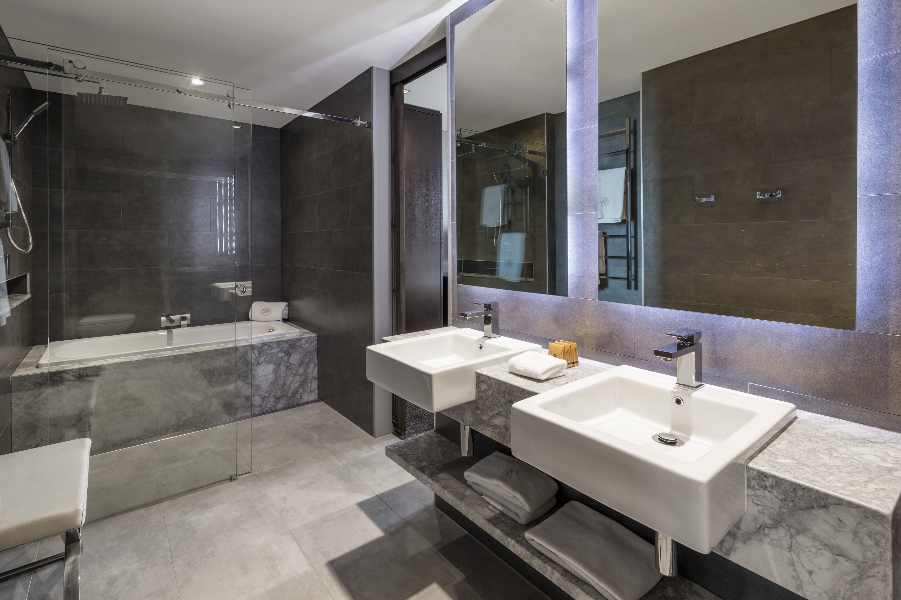 mg suite | bathroom | designer toiletries, hair dryer, bathrobes, slippers